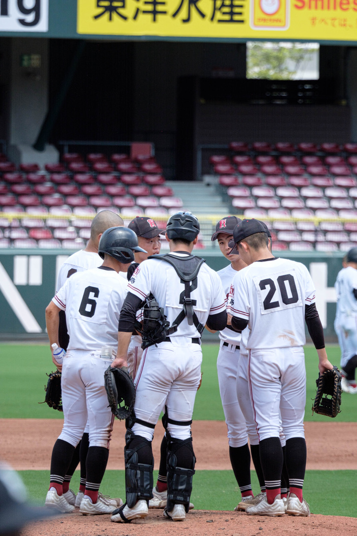 Baseball players gathered for a conversation on the field