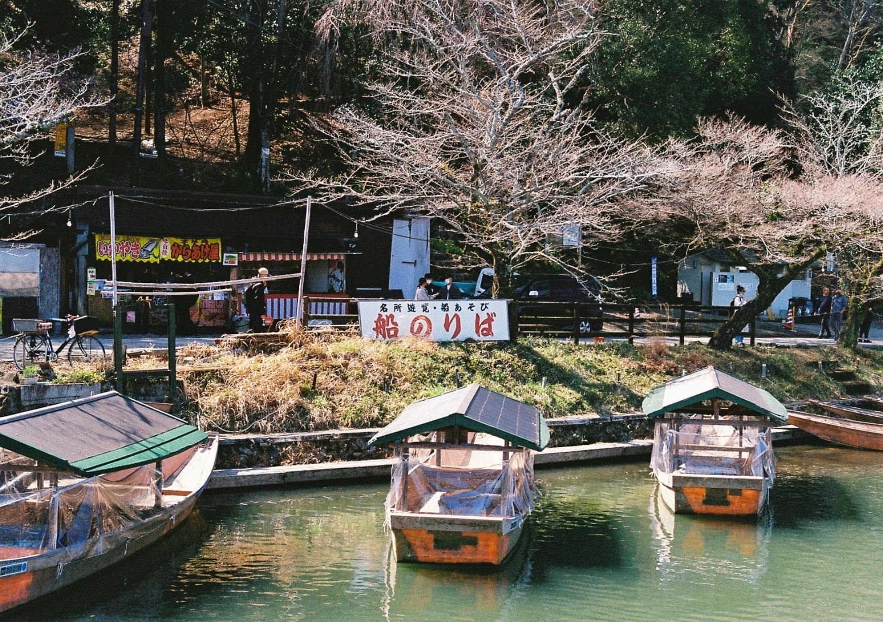Small boats waiting beside a quiet pond