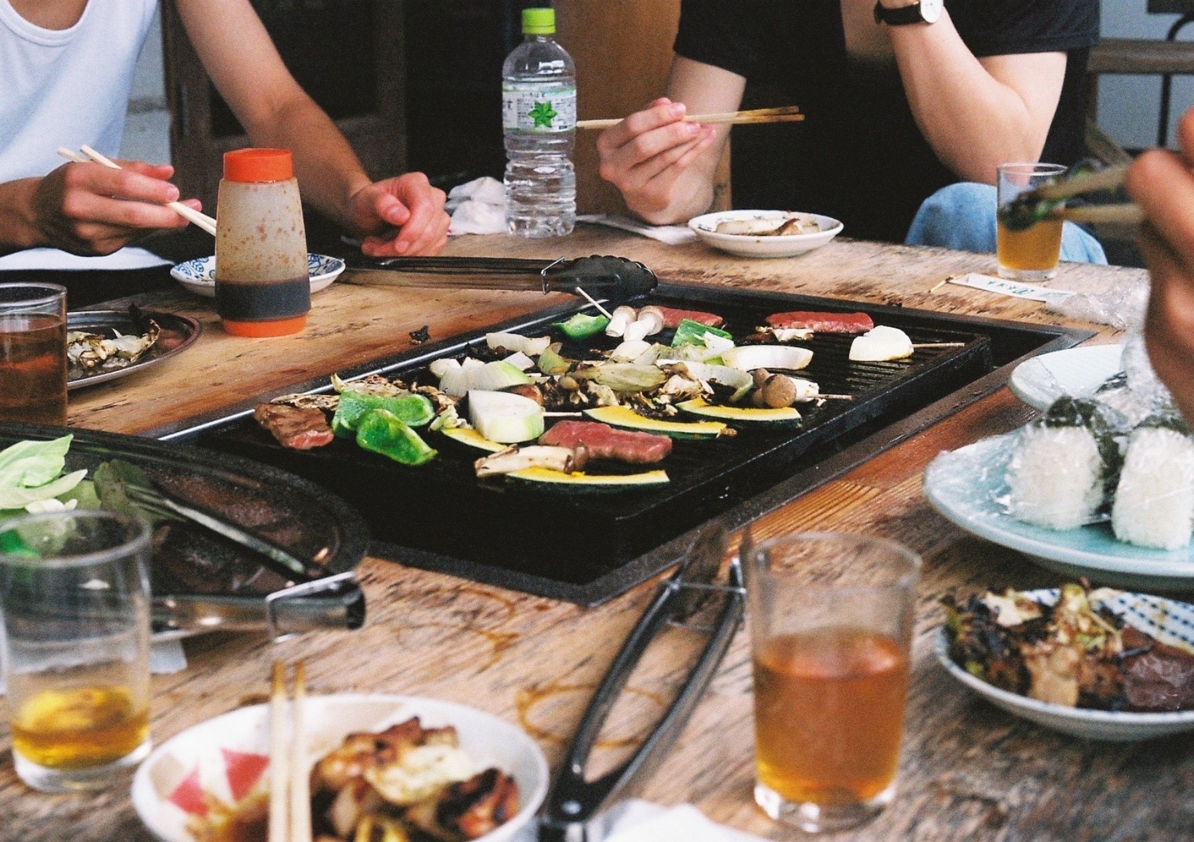 Friends gathered around a table for an outdoor barbecue