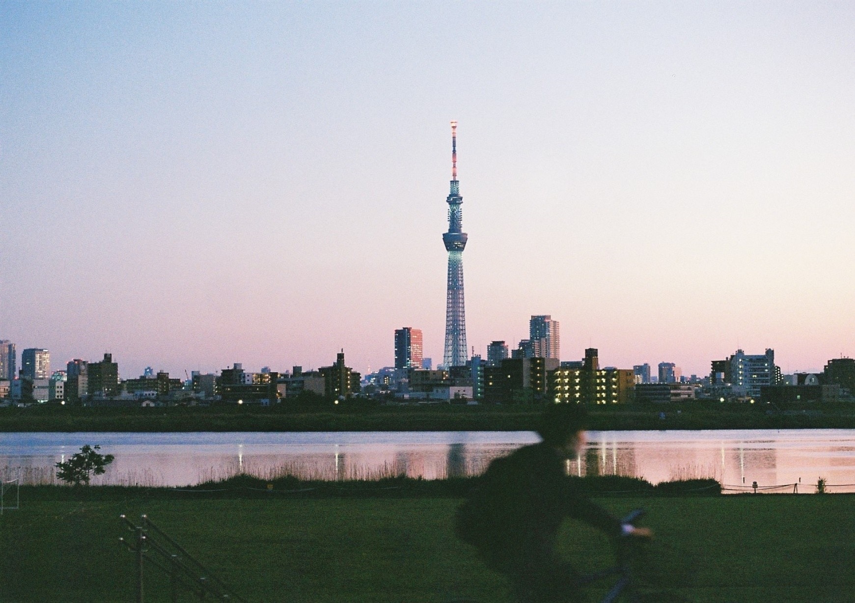 Tokyo Skytree rising beyond the water at dusk