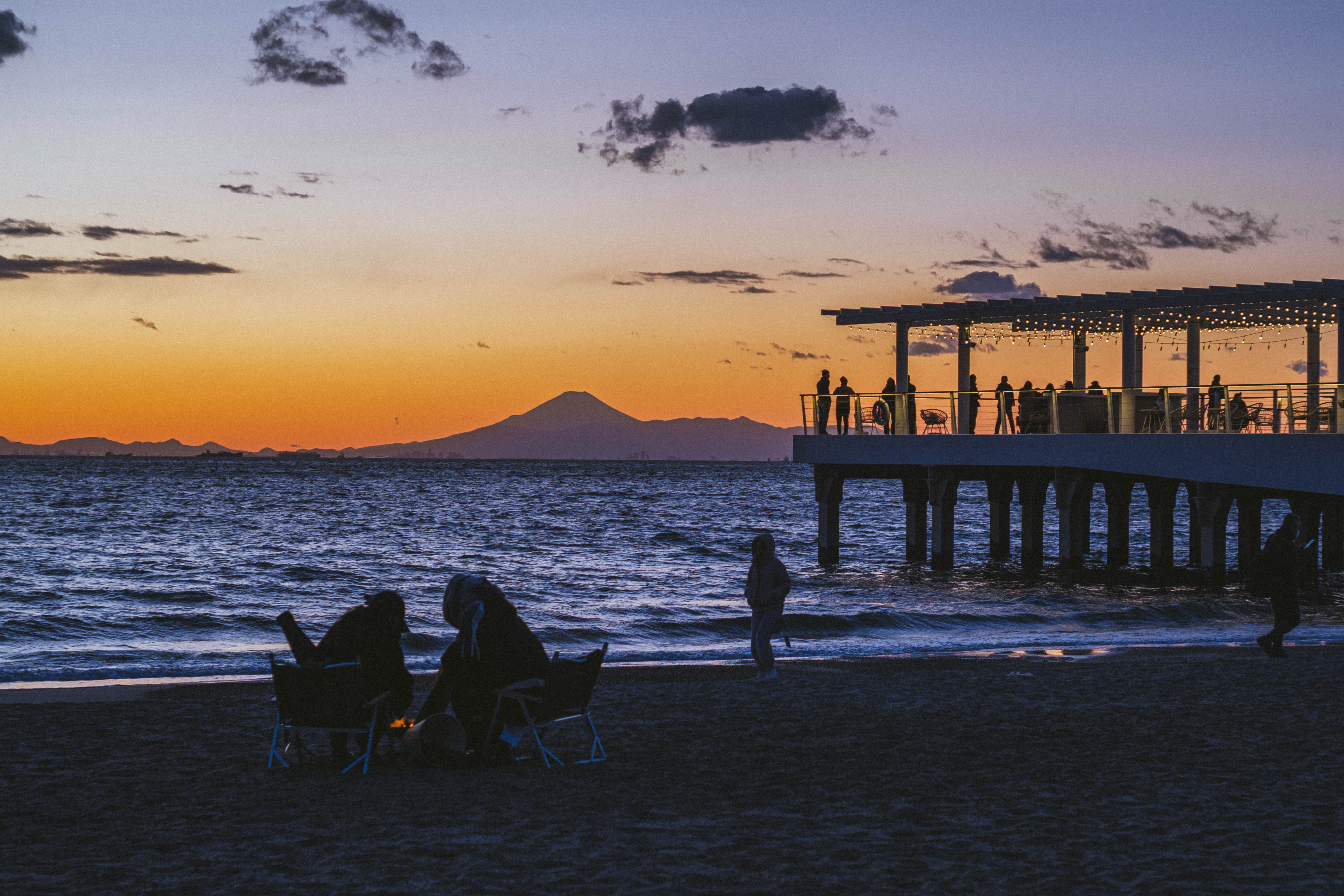 A pier and Mount Fuji beneath a violet evening sky