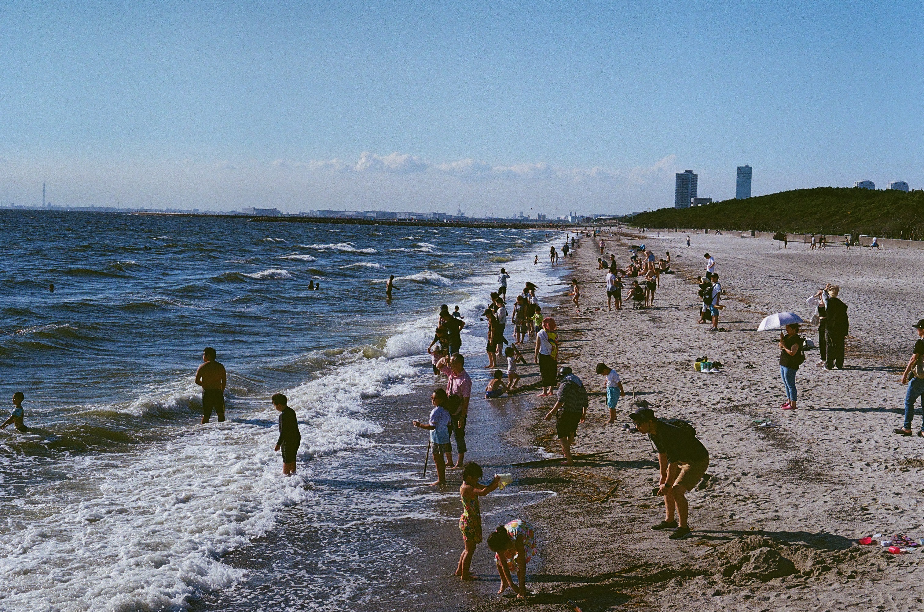 People spending an afternoon along a busy beach