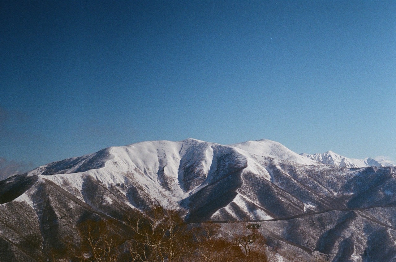 A snow-covered mountain beneath a clear blue sky